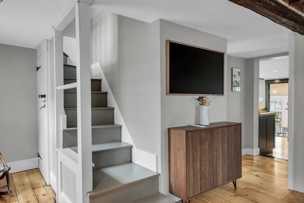 16 River Street Salem, MA 01970 - Photo 22 of 37 a view of hallway with stairs and wooden floor