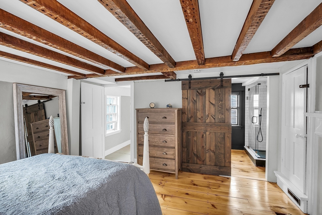 16 River Street Salem, MA 01970 - Photo 24 of 37 a view of a hallway with wooden floor and staircase