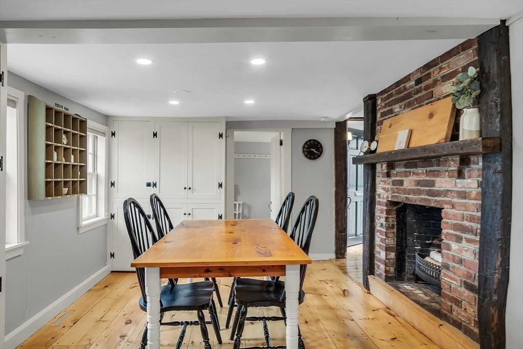 16 River Street Salem, MA 01970 - Photo 9 of 37 a dining room with furniture and a fireplace