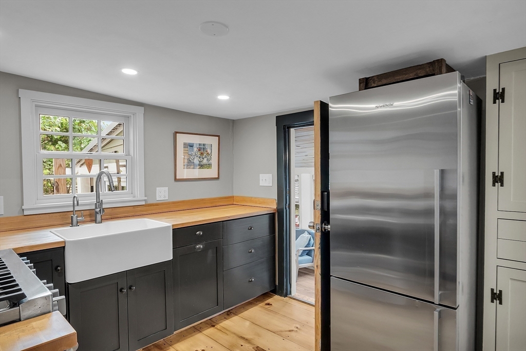 16 River Street Salem, MA 01970 - Photo 10 of 37 a kitchen with stainless steel appliances granite countertop a refrigerator and a sink