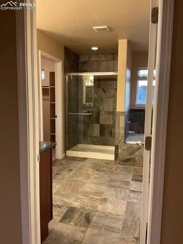 a bathroom with a glass shower door