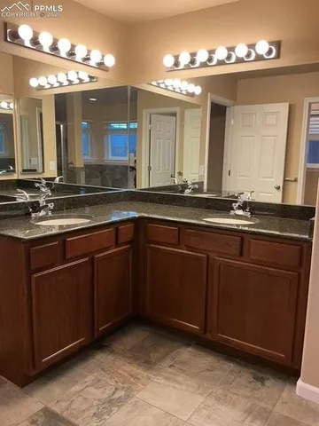 a bathroom with a sink and a large mirror