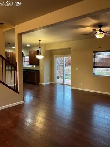 a view of a room wooden floor and a kitchen