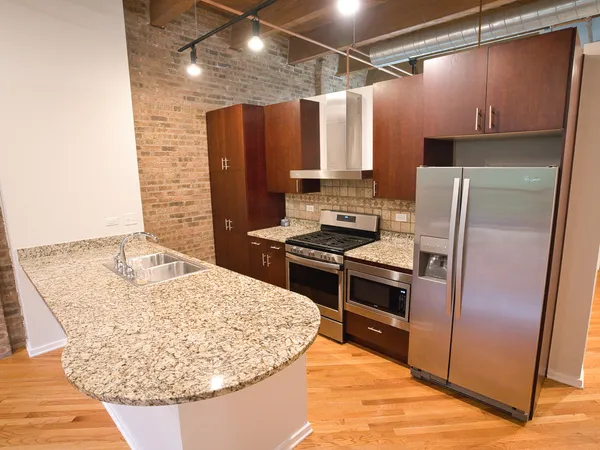 a kitchen with a refrigerator and a sink