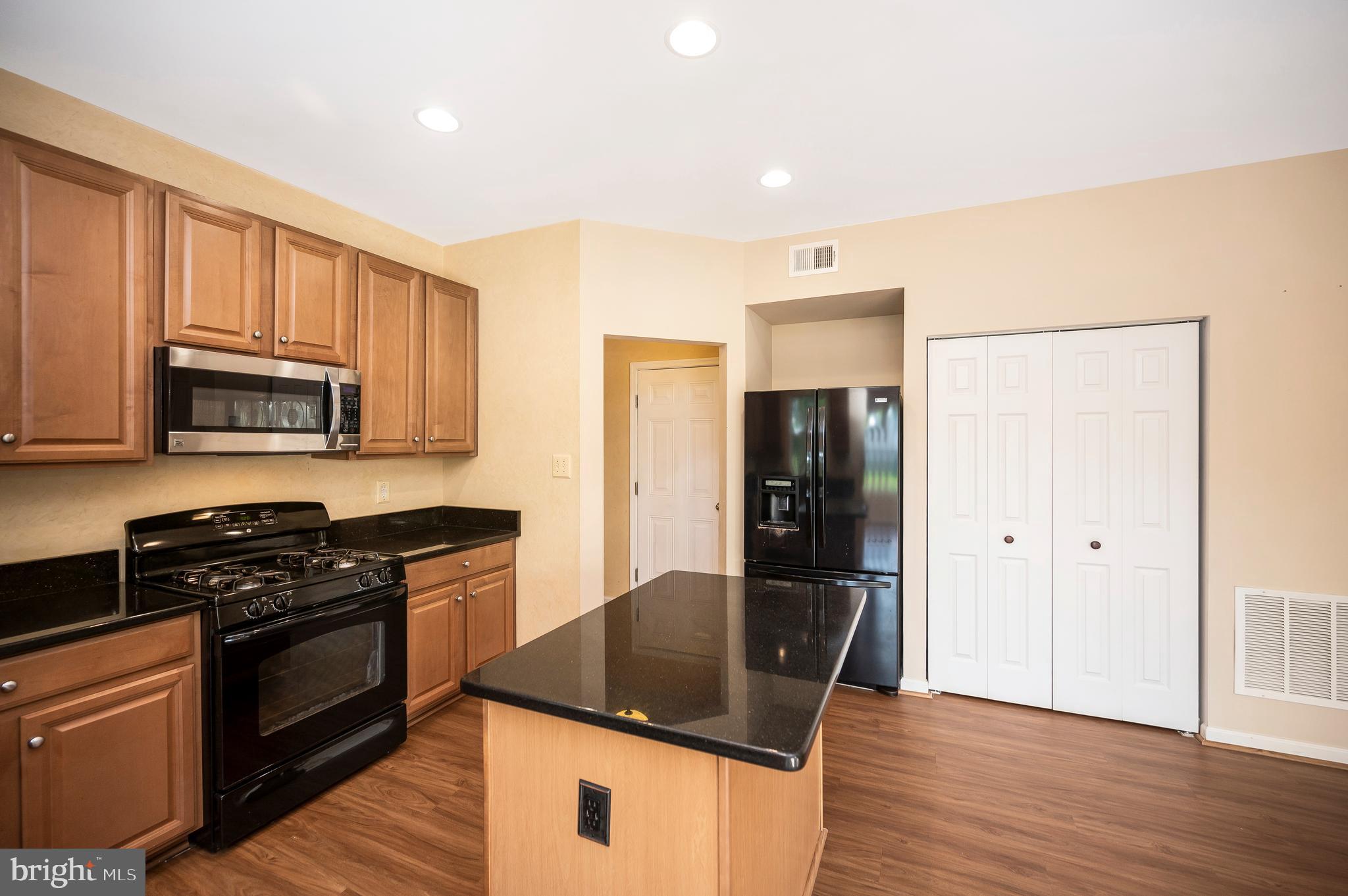 3308 Boathouse Road Warrenton, VA 20187 - Photo 14 of 59 a kitchen with granite countertop a refrigerator stove top oven and sink