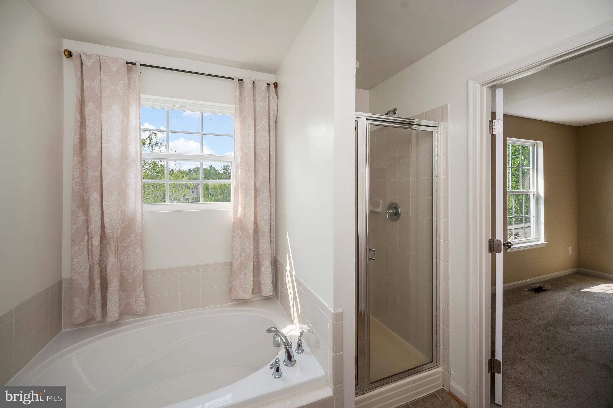 3308 Boathouse Road Warrenton, VA 20187 - Photo 29 of 59 a bathroom with a bathtub and a shower