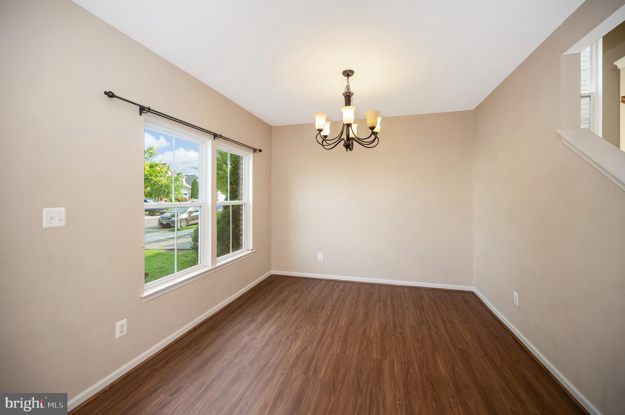 3308 Boathouse Road Warrenton, VA 20187 - Photo 4 of 59 a view of an empty room with wooden floor and a window