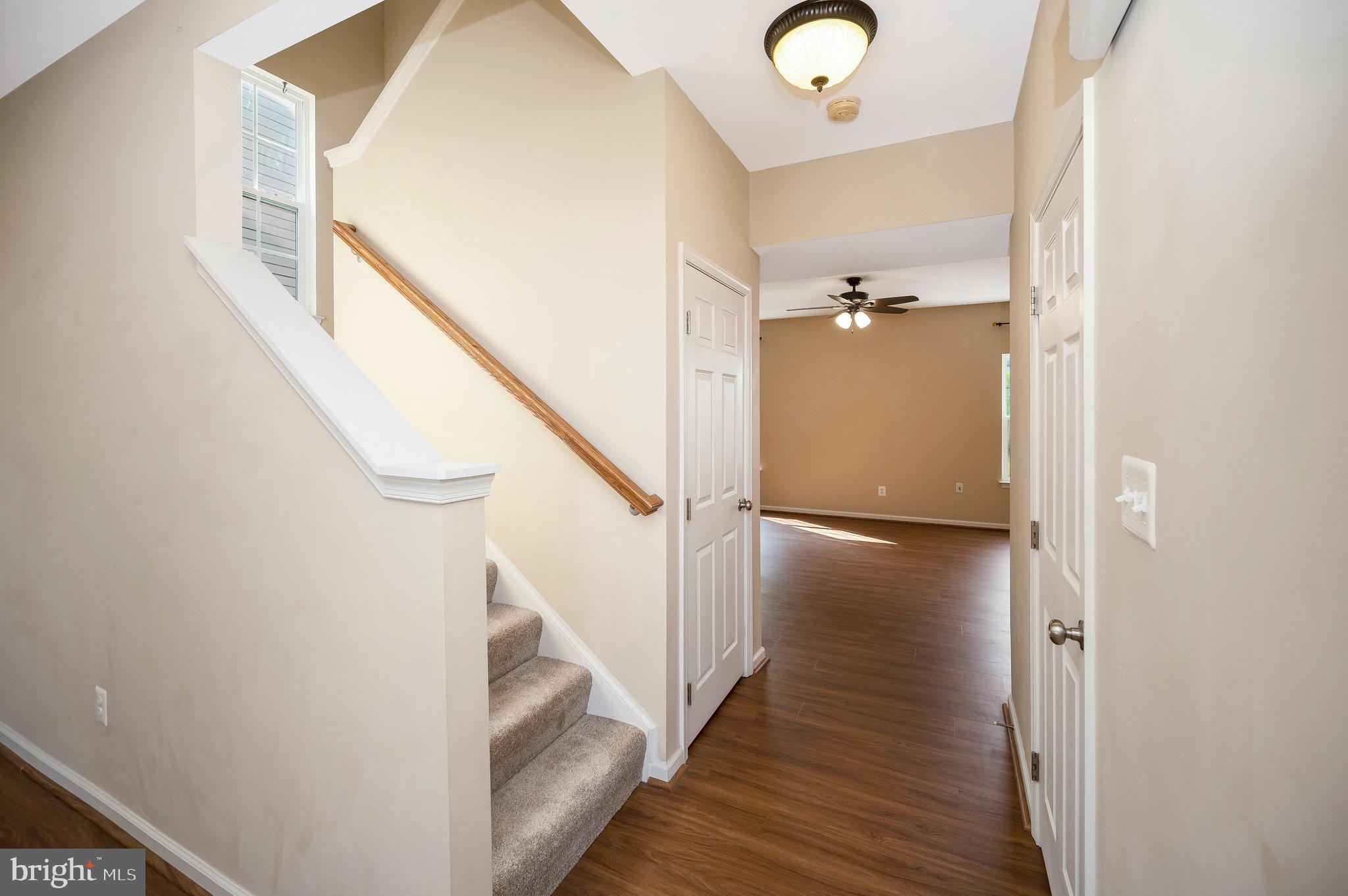 3308 Boathouse Road Warrenton, VA 20187 - Photo 6 of 59 a view of a hallway with wooden floor and staircase