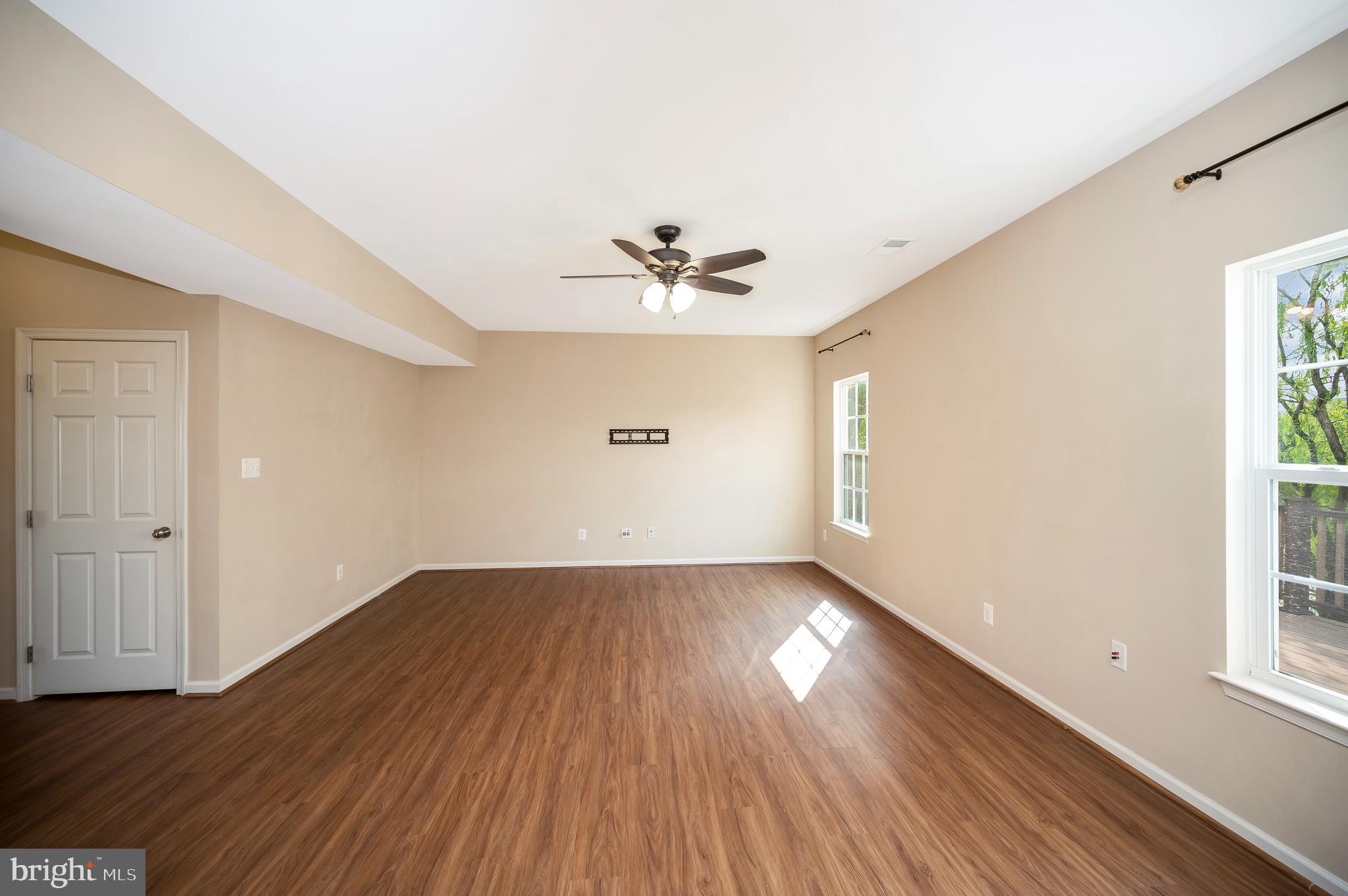 3308 Boathouse Road Warrenton, VA 20187 - Photo 8 of 59 an empty room with wooden floor and windows