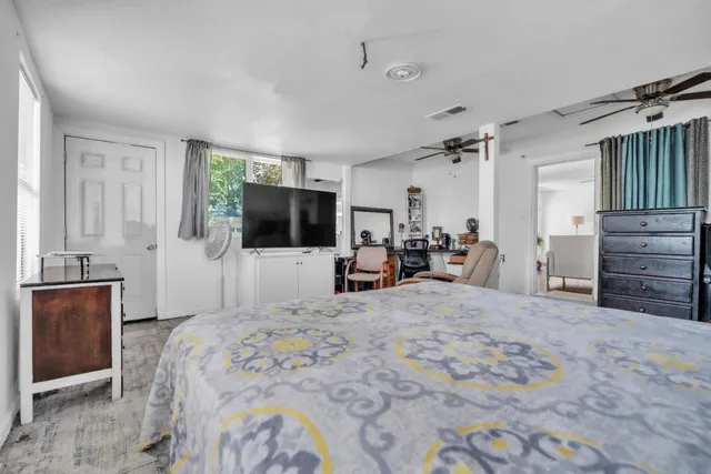 a large bedroom with a bed and furniture