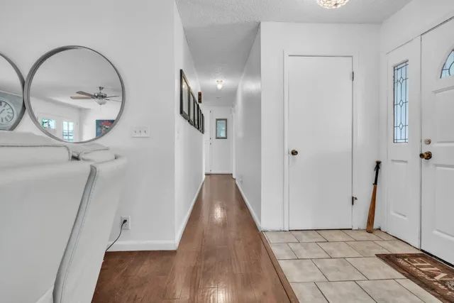 a view of a livingroom with wooden floor and entryway