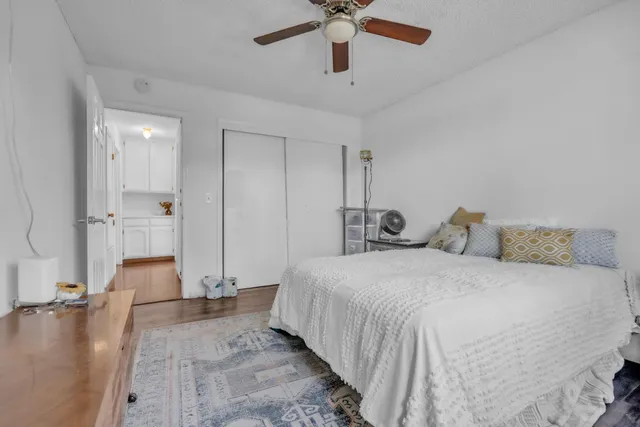 a spacious bedroom with a bed and ceiling fan
