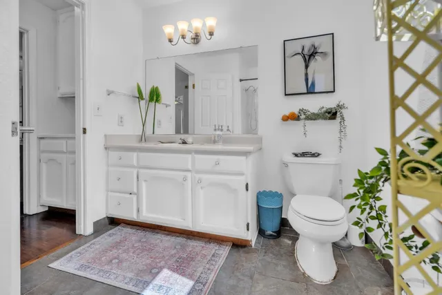 a bathroom with a sink mirror vanity and toilet
