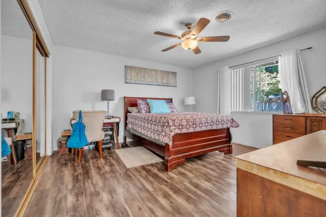 a bedroom with a bed and a view of kitchen