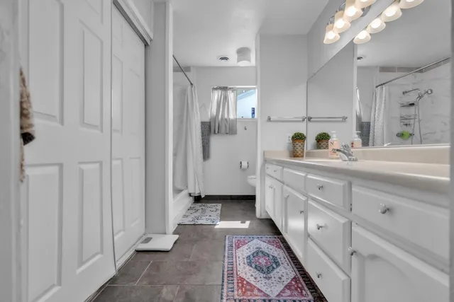 a spacious bathroom with double vanity and mirrors