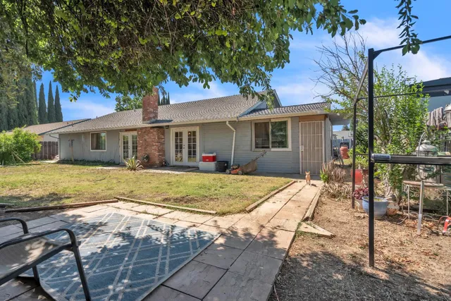 a view of house with yard outdoor seating