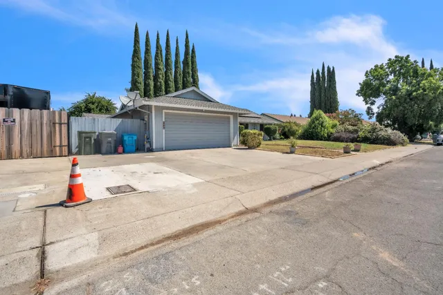 an aerial view of a house with a yard and lake view