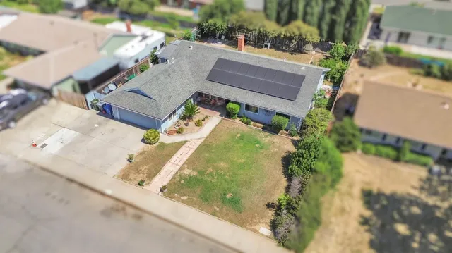 an aerial view of residential houses with outdoor space