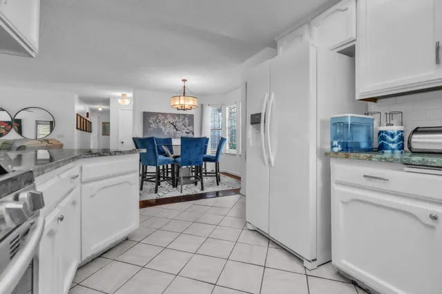 a kitchen with stainless steel appliances a refrigerator sink and cabinets