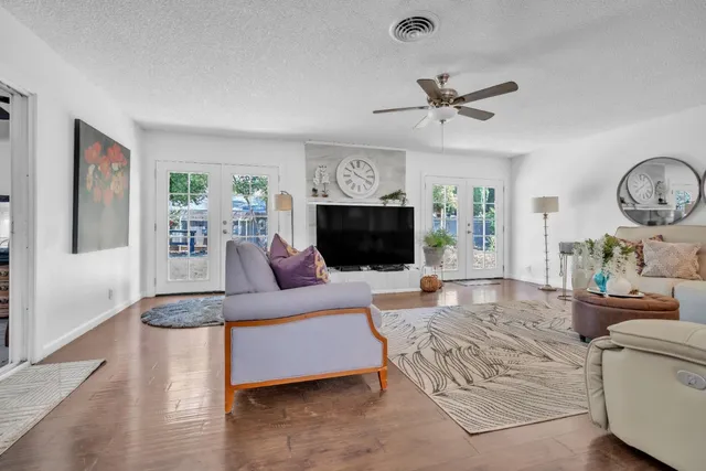 a living room with furniture a fireplace and a flat screen tv