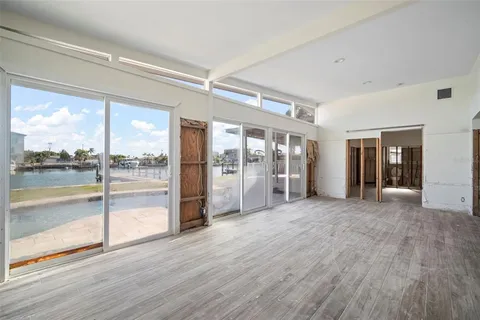 a big room with wooden floor and windows