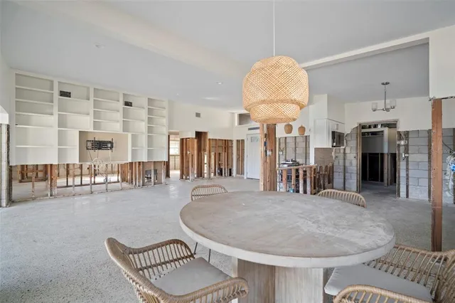 a dining room with furniture and a chandelier