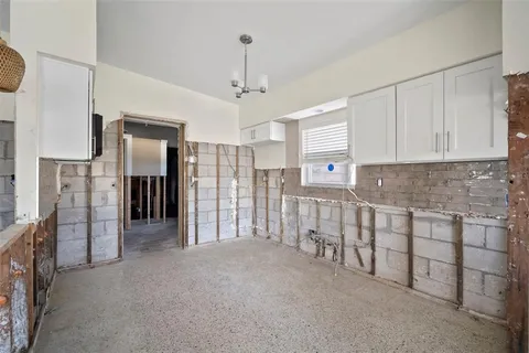 a view of a kitchen with refrigerator and cabinets