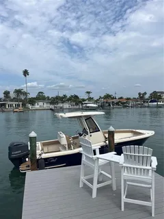 a view of a lake with outdoor seating and city view