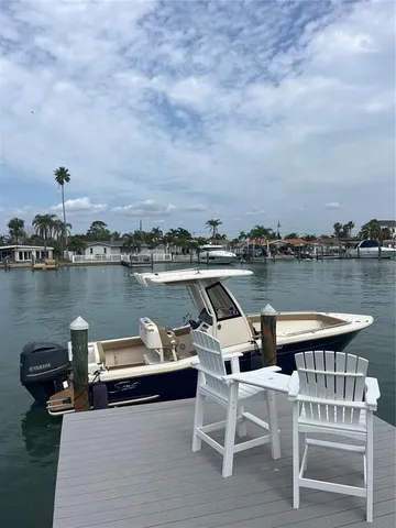 a view of a lake with outdoor seating and city view