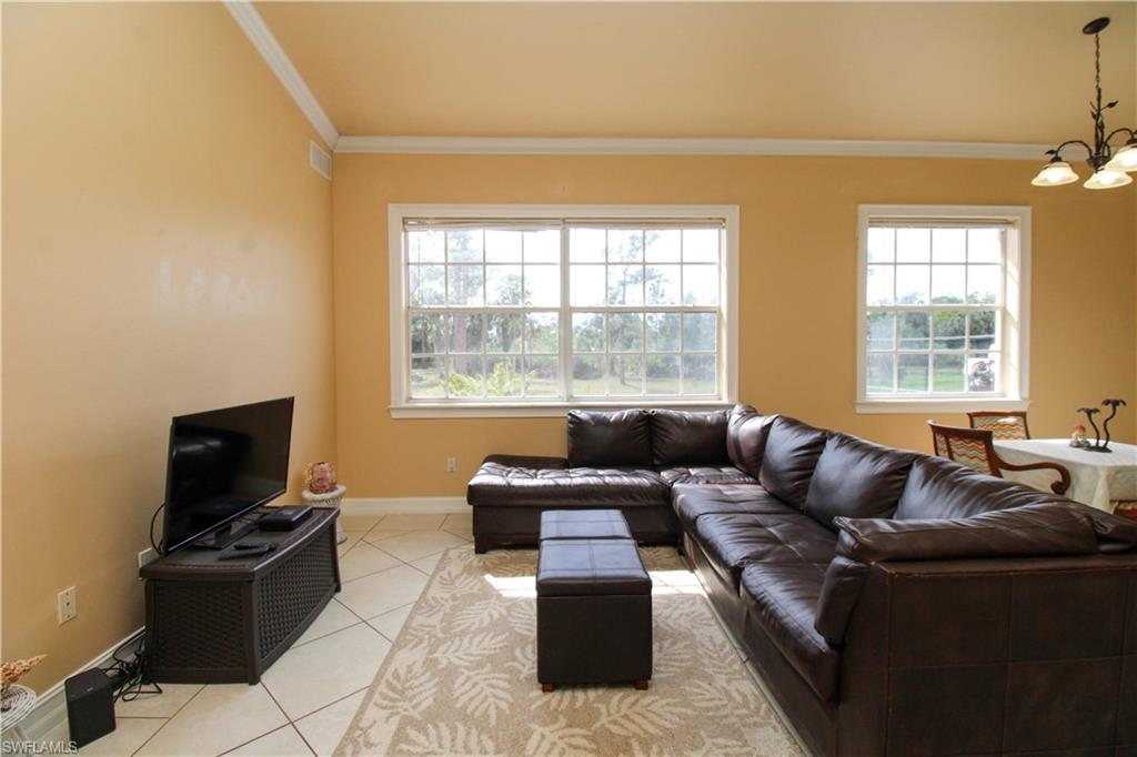 2310 2nd Avenue Southeast Naples, FL 34117 - Photo 11 of 43 a living room with furniture and a flat screen tv