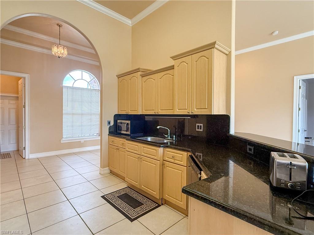 2310 2nd Avenue Southeast Naples, FL 34117 - Photo 19 of 43 a kitchen with a sink a counter top space and cabinets