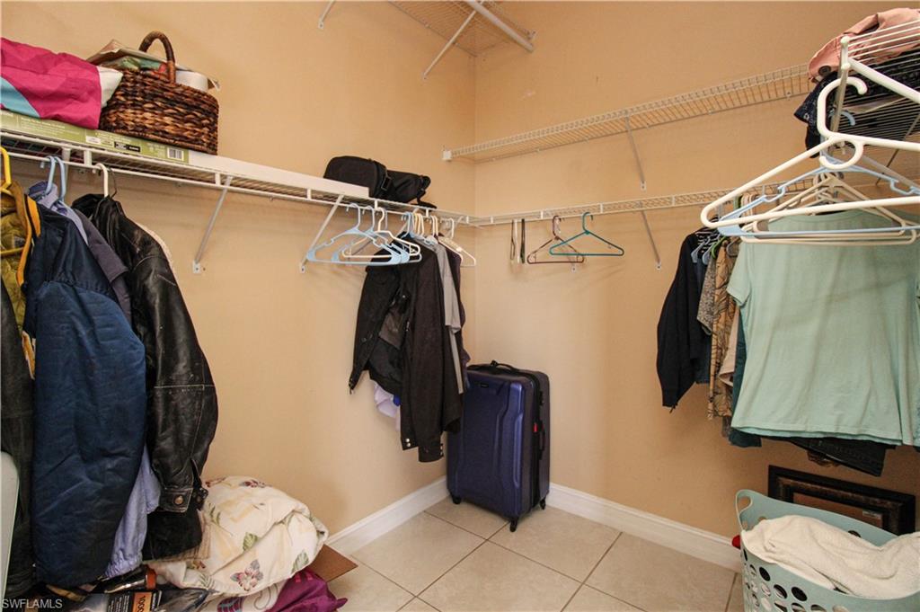 2310 2nd Avenue Southeast Naples, FL 34117 - Photo 24 of 43 a view of walk in closet with clothes and shoes