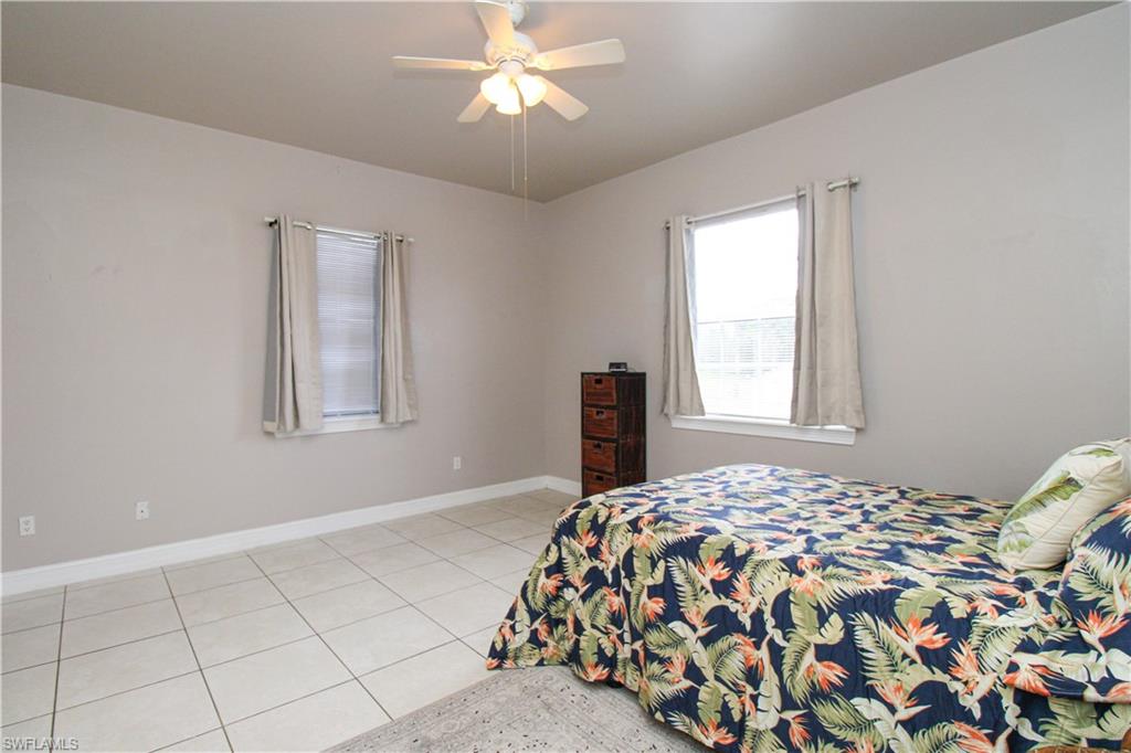 2310 2nd Avenue Southeast Naples, FL 34117 - Photo 26 of 43 a bedroom with a bed and a window