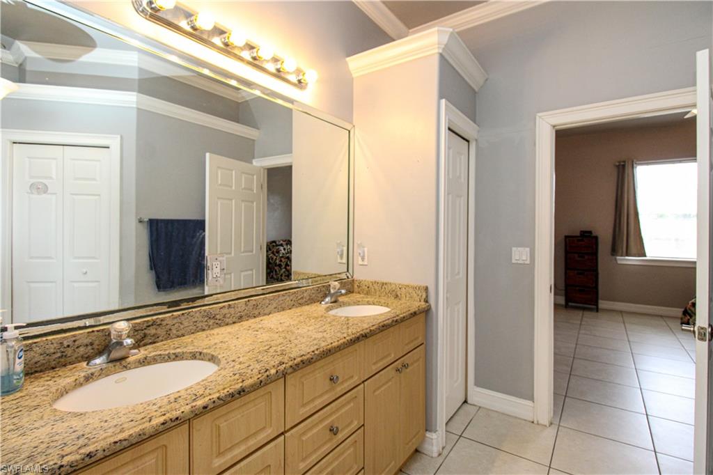 2310 2nd Avenue Southeast Naples, FL 34117 - Photo 30 of 43 a bathroom with a granite countertop sink and a mirror