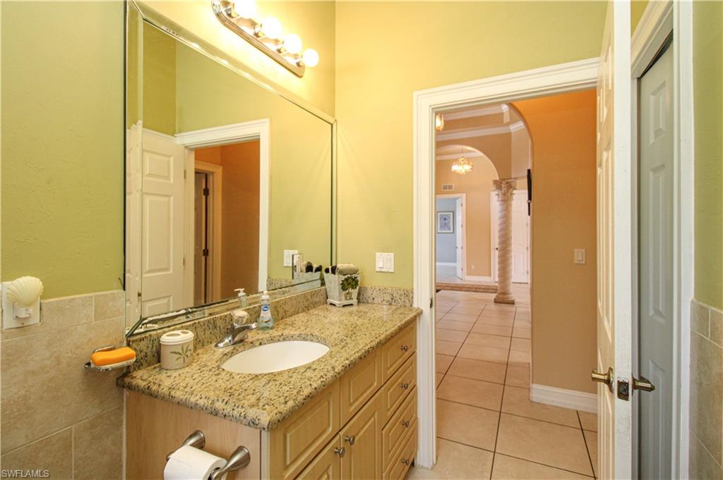 2310 2nd Avenue Southeast Naples, FL 34117 - Photo 34 of 43 a bathroom with a granite countertop sink and a mirror