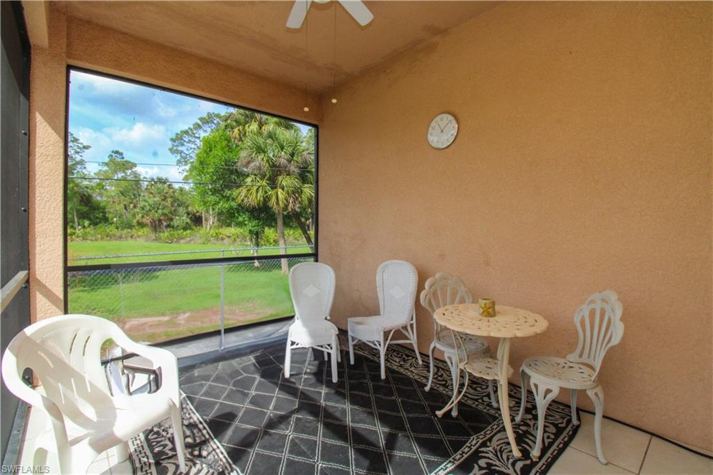2310 2nd Avenue Southeast Naples, FL 34117 - Photo 36 of 43 a view of a chairs and table in patio and a yard