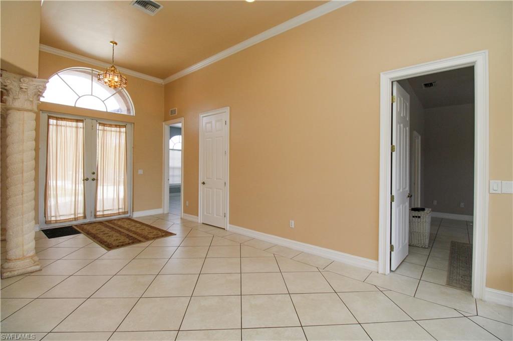 2310 2nd Avenue Southeast Naples, FL 34117 - Photo 5 of 43 en empty room with windows and chandelier