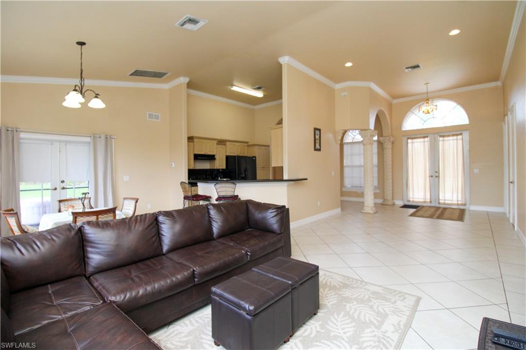 2310 2nd Avenue Southeast Naples, FL 34117 - Photo 10 of 43 a living room with furniture and a chandelier