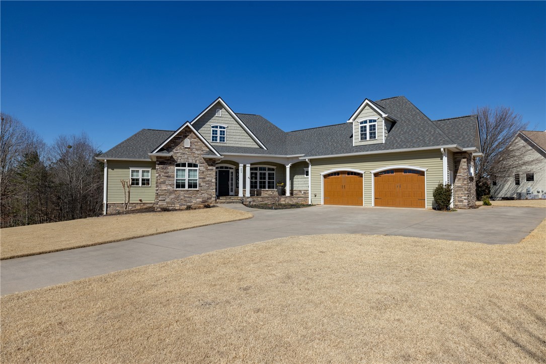 209 Crestridge Drive Seneca, SC 29672 - Photo 1 of 49 This residence showcases a blend of natural stone and siding, complemented by a spacious driveway.