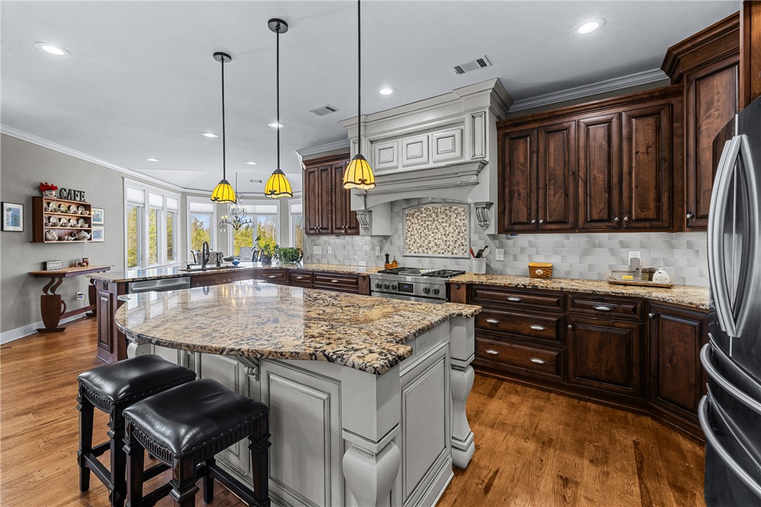 209 Crestridge Drive Seneca, SC 29672 - Photo 12 of 49 This kitchen features a spacious island and rich wood cabinetry, perfect for culinary endeavors.