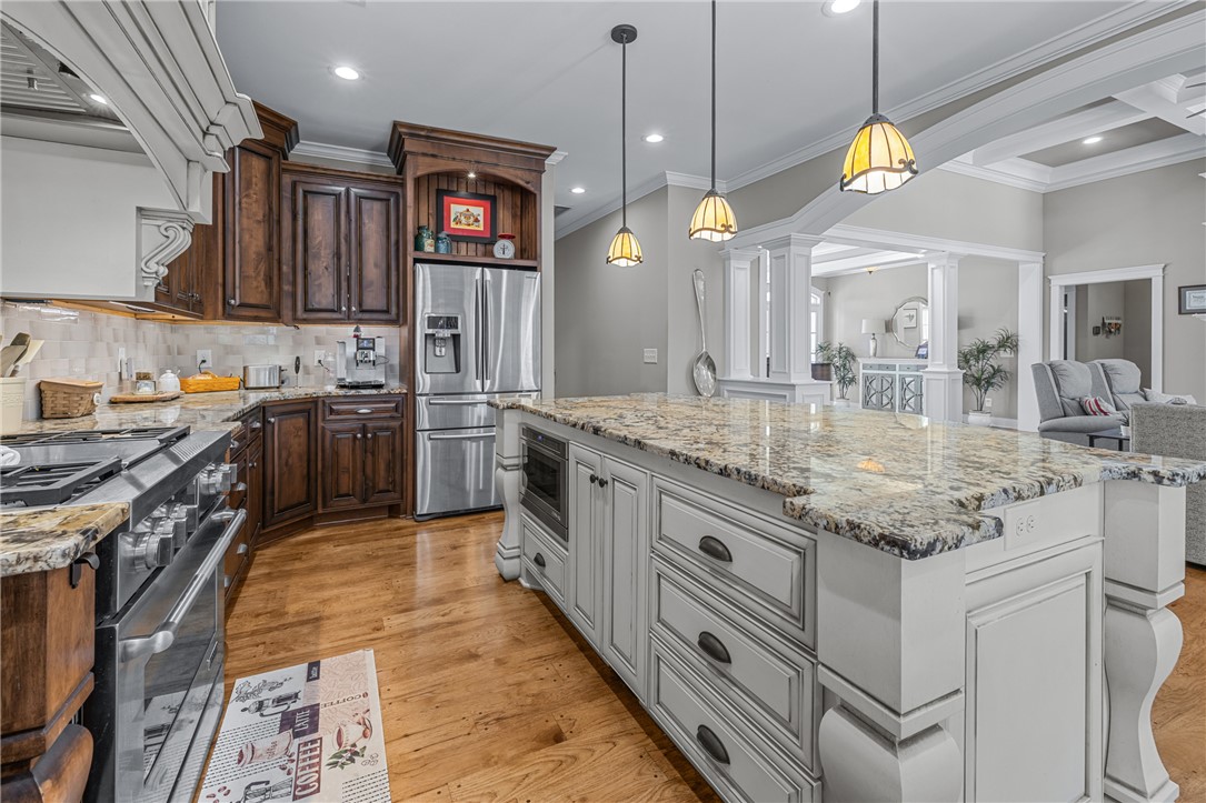 209 Crestridge Drive Seneca, SC 29672 - Photo 15 of 49 This spacious kitchen offers ample granite counter space, rich wood cabinetry, and a central island.