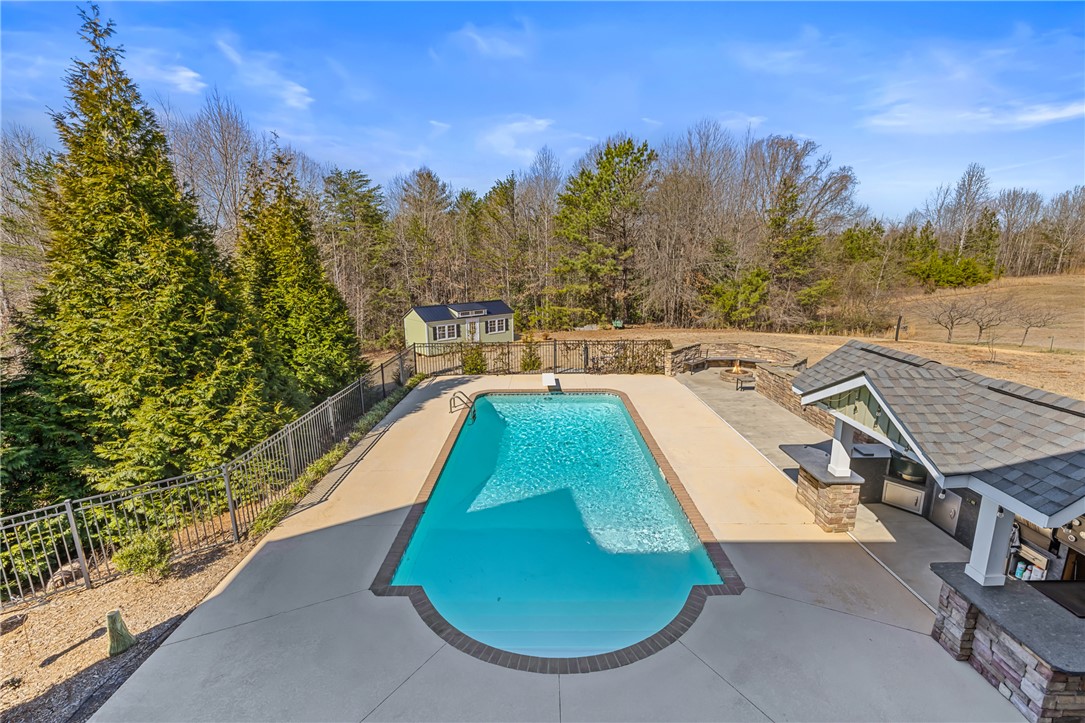 209 Crestridge Drive Seneca, SC 29672 - Photo 20 of 49 This spacious backyard features a shimmering pool, an outdoor kitchen, and a charming shed.