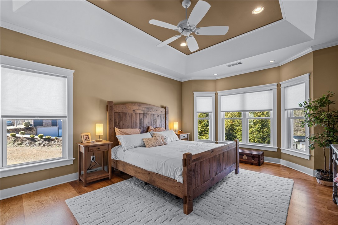 209 Crestridge Drive Seneca, SC 29672 - Photo 21 of 49 This spacious bedroom features ample natural light and elegant tray ceilings.