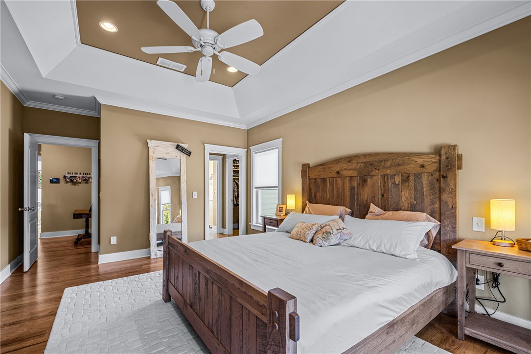 209 Crestridge Drive Seneca, SC 29672 - Photo 22 of 49 This spacious primary bedroom features rich wood flooring and a classic ceiling fan, perfect for unwinding.