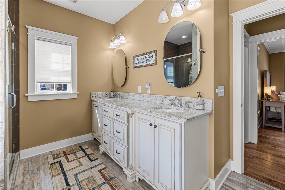 209 Crestridge Drive Seneca, SC 29672 - Photo 24 of 49 This primary bathroom features a dual vanity with elegant granite countertops and a spacious shower.