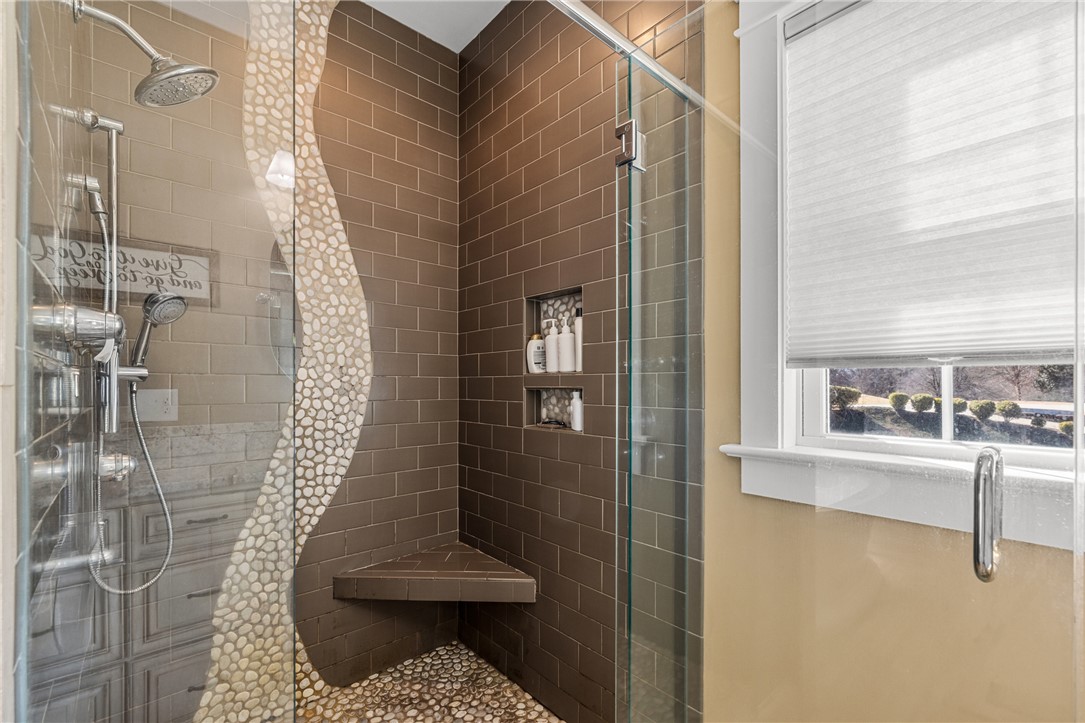 209 Crestridge Drive Seneca, SC 29672 - Photo 25 of 49 This modern bathroom features a spacious shower with sleek design elements and natural light.