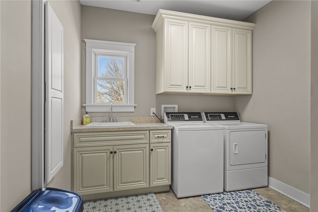 209 Crestridge Drive Seneca, SC 29672 - Photo 28 of 49 This laundry room combines practical design with ample storage and a cheerful window.