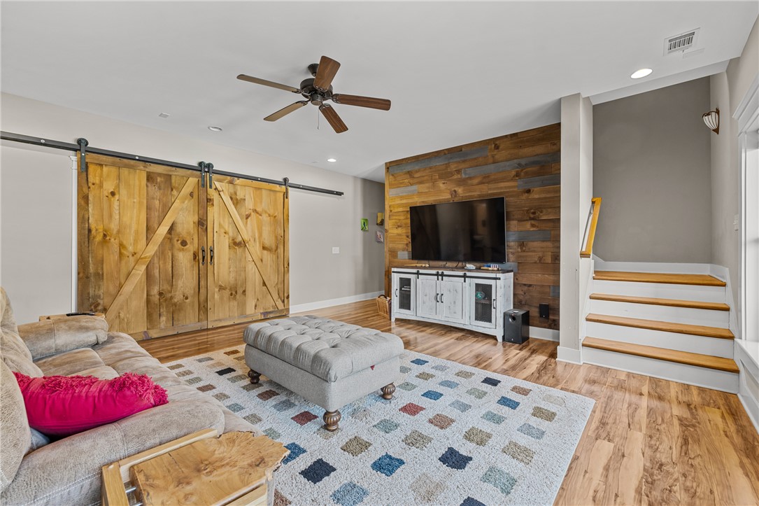 209 Crestridge Drive Seneca, SC 29672 - Photo 32 of 49 This inviting living area boasts a warm, rustic accent wall and convenient barn doors.