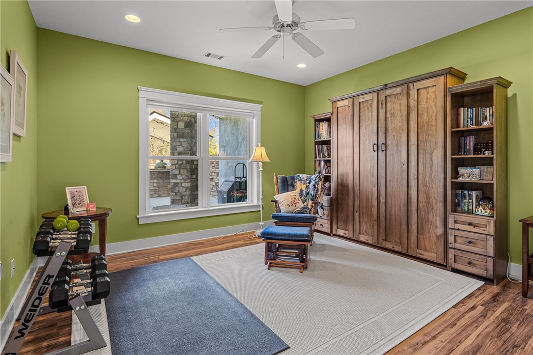 209 Crestridge Drive Seneca, SC 29672 - Photo 35 of 49 This versatile room features warm wood flooring and a large window, creating a bright and inviting atmosphere.