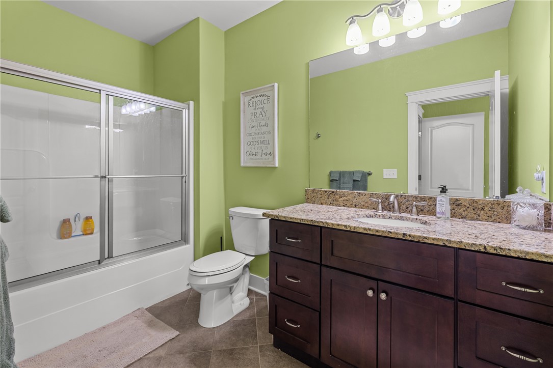 209 Crestridge Drive Seneca, SC 29672 - Photo 38 of 49 This primary bathroom offers a shower, toilet, and vanity with a granite counter and mirror.